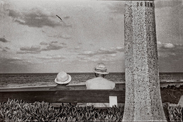 Seated Couple With Hats